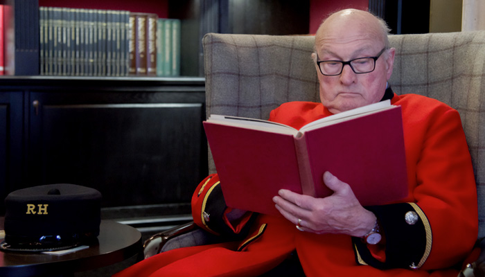 Chelsea Pensioner, and Britain's Got Talent Winner, Colin Thackery sits in The Royal Hospital Chelsea Library reading.