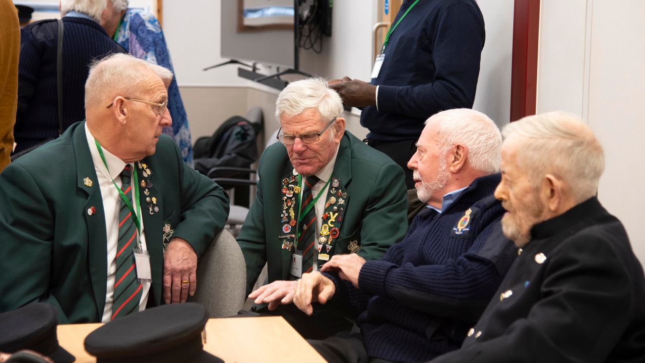 Chelsea Pensioners speak with other retired military veterans at the Royal Hospital Chelsea