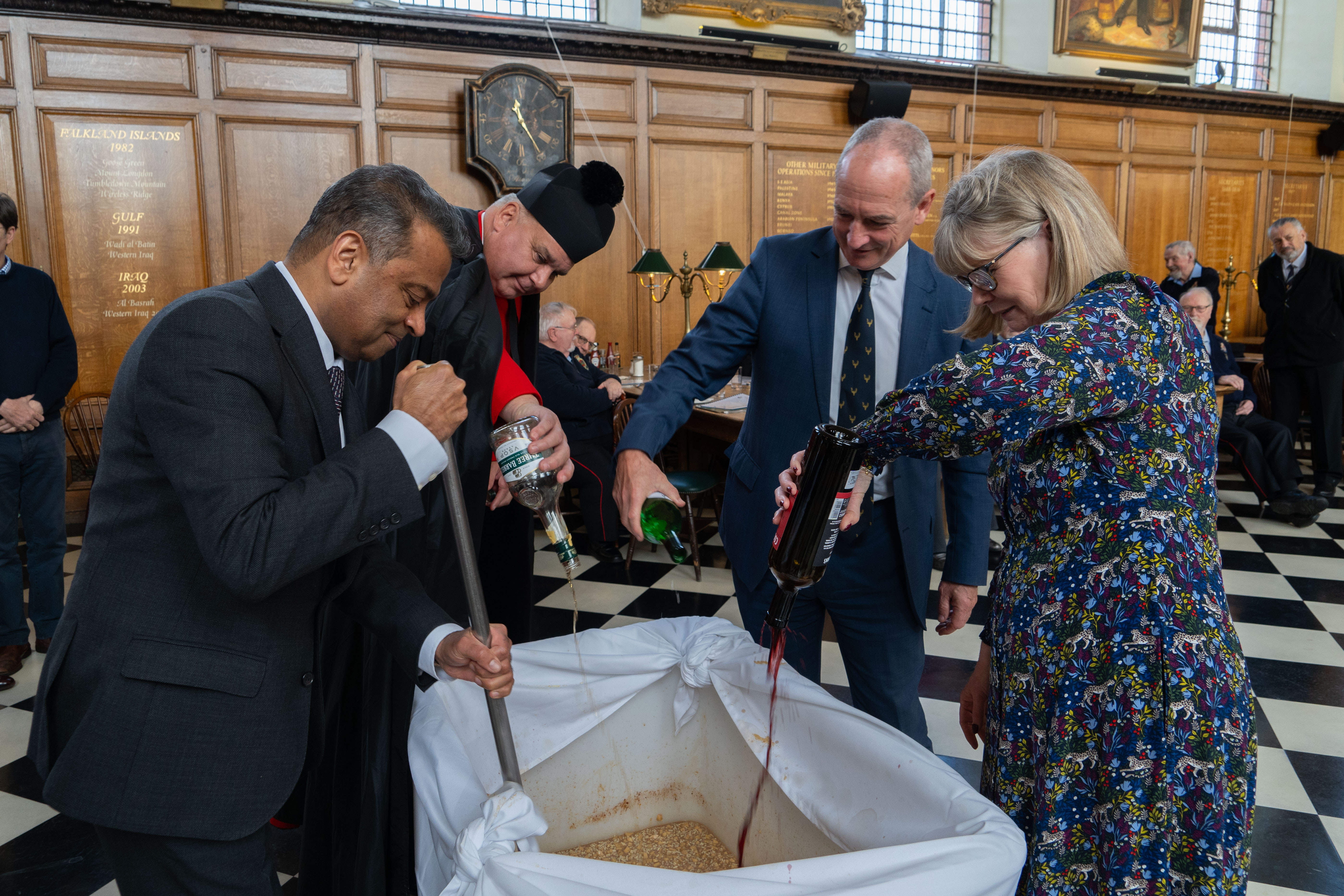 Staff of the Royal Hospital adding ingredients to the Christmas pudding mixture