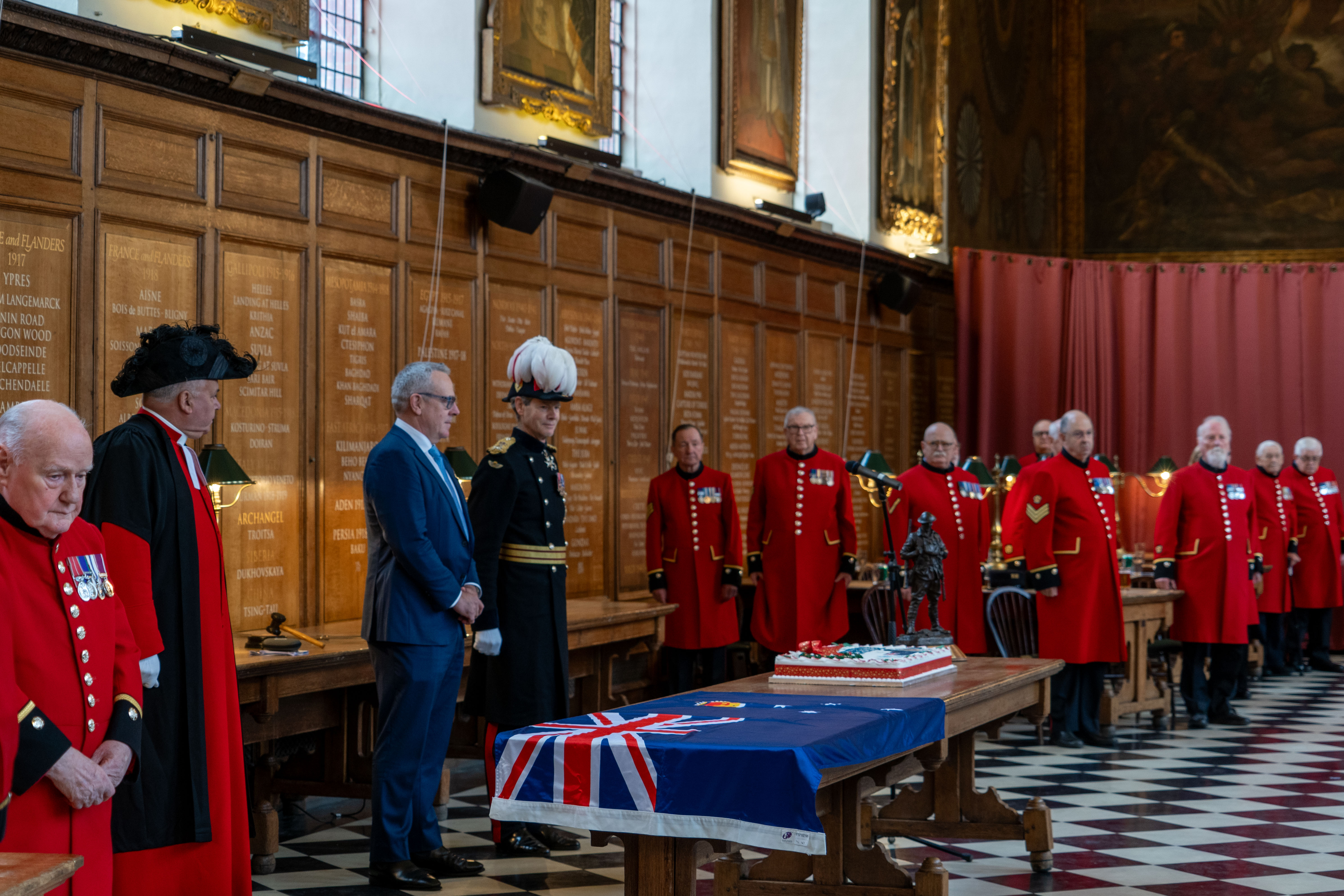 Governor, Chelsea Pensioners and Agent General for Victoria stand in the Great Hall for the Ceremony of the Christmas cake