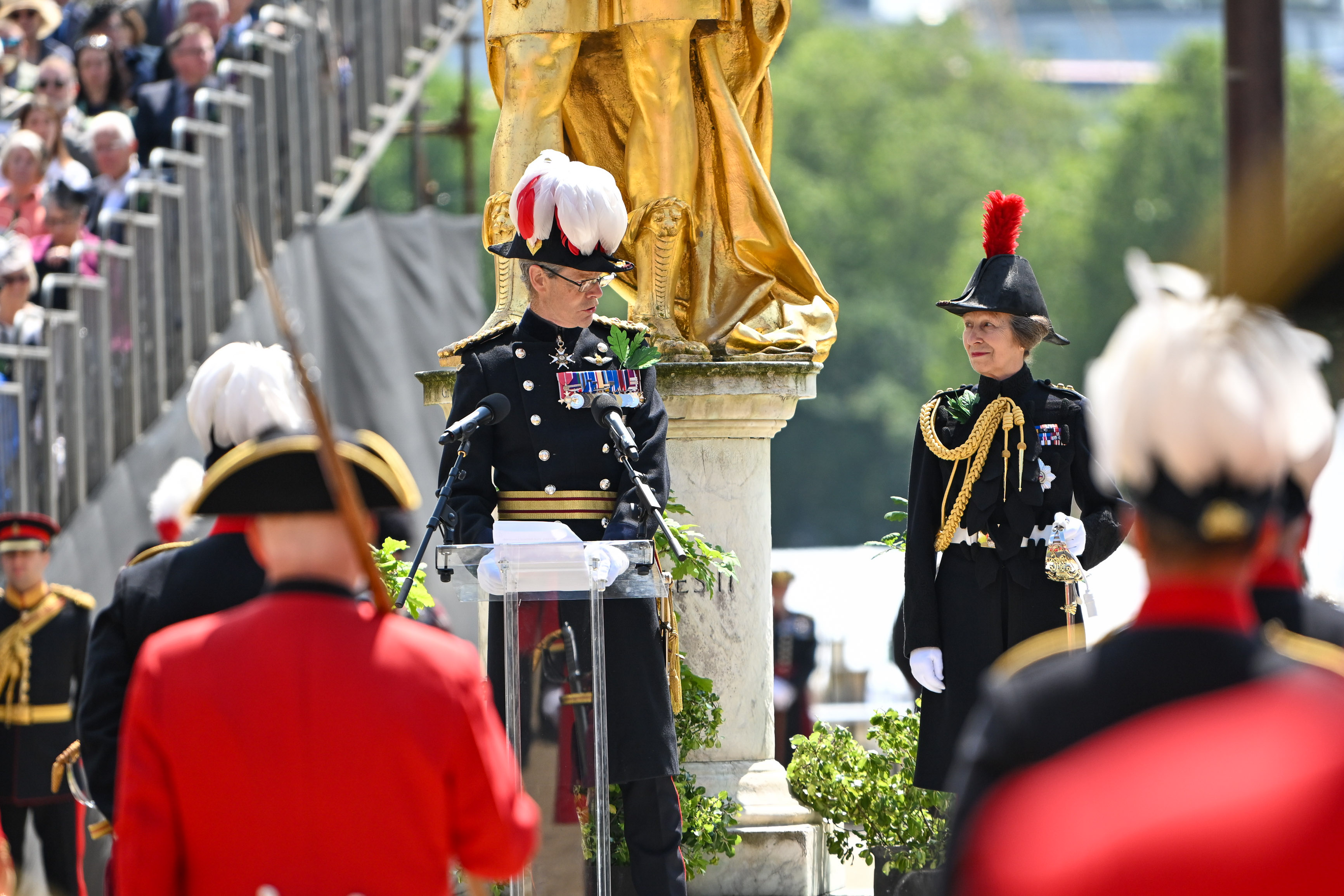 Governor of the Royal Hospital Chelsea and The Princess Royal giving a speech in front of King Charles II statue
