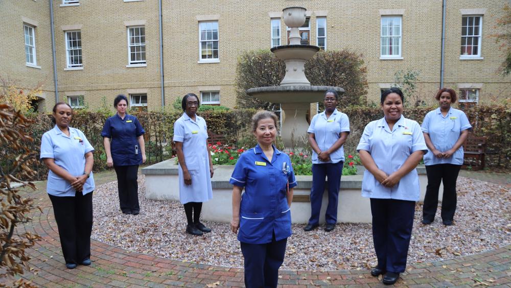 Nurses and care staff gather in the courtyard of the Margaret Thatcher Infirmary at The Royal Hospital Chelsea