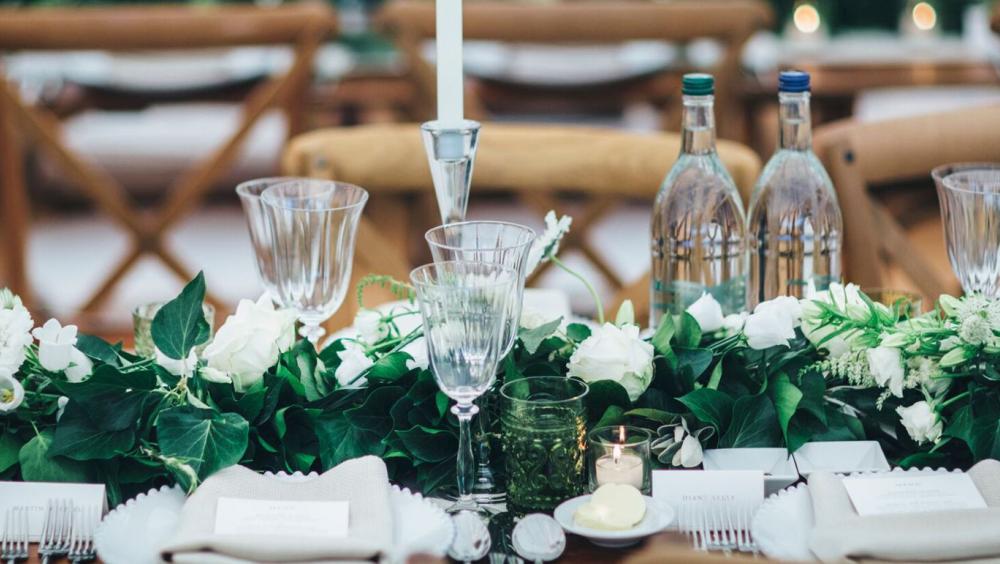 table set for fancy meal with flowers and candles