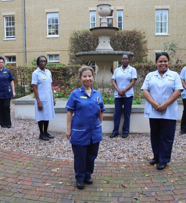 Nurses and care staff gather in the courtyard of the Margaret Thatcher Infirmary at The Royal Hospital Chelsea