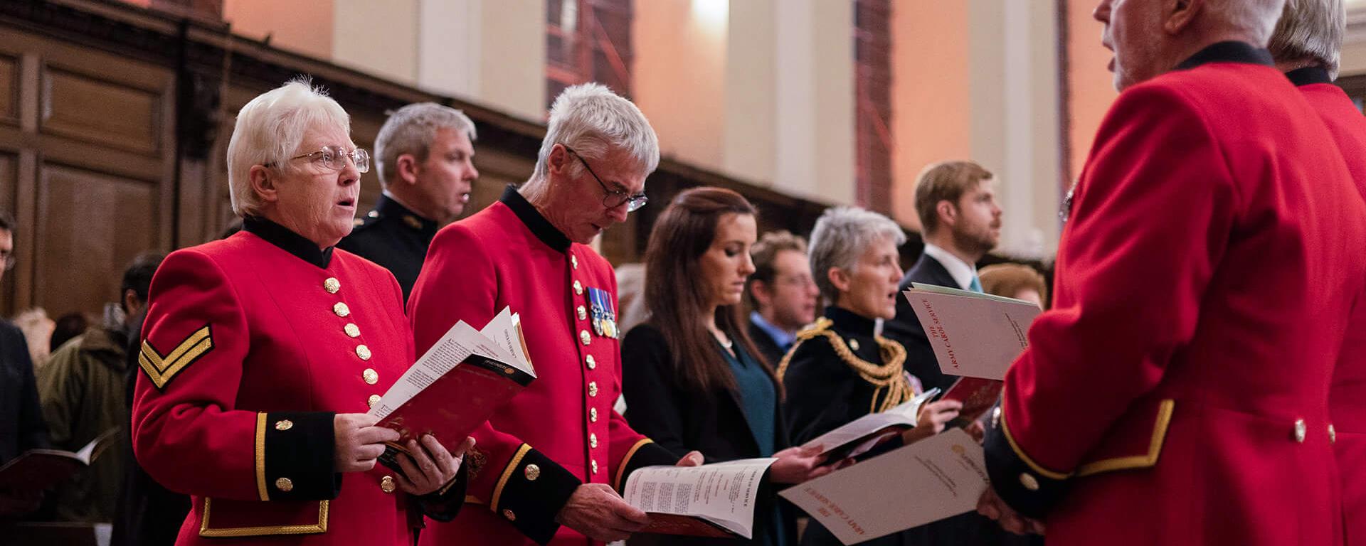 Chelsea Pensioners singing amongst the congregation at a Wren Chapel Service