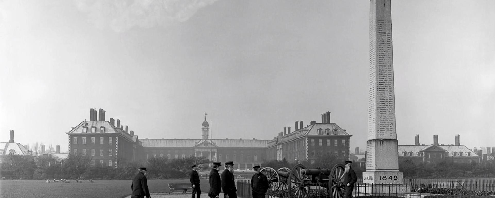 Historic photo of the Royal Hospital Chelsea from the south grounds, featuring Chelsea Pensioners & the obelisk war memorial 
