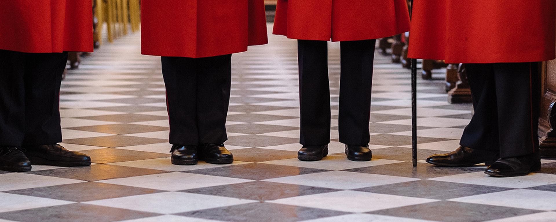 Chelsea Pensioners standing in the Wren Chapel, cropped from the Bottom of the scarlet coat to the floor.