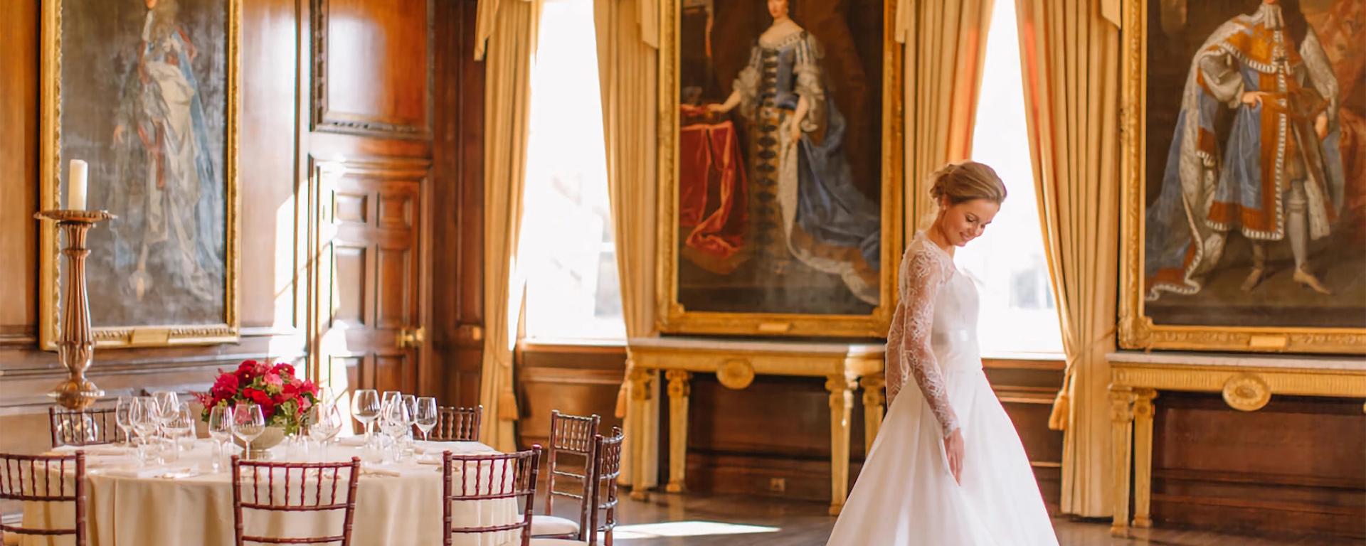 An elegant bride stands in a white flowing dress in the opulent State Apartments at the Royal Hospital Chelsea