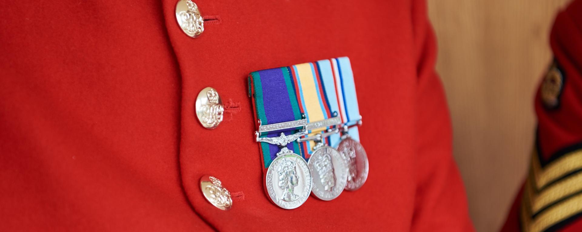 Become a Chelsea Pensioner - Close up photo of Chelsea Pensioner Scarlet Coat Adorned with Medals