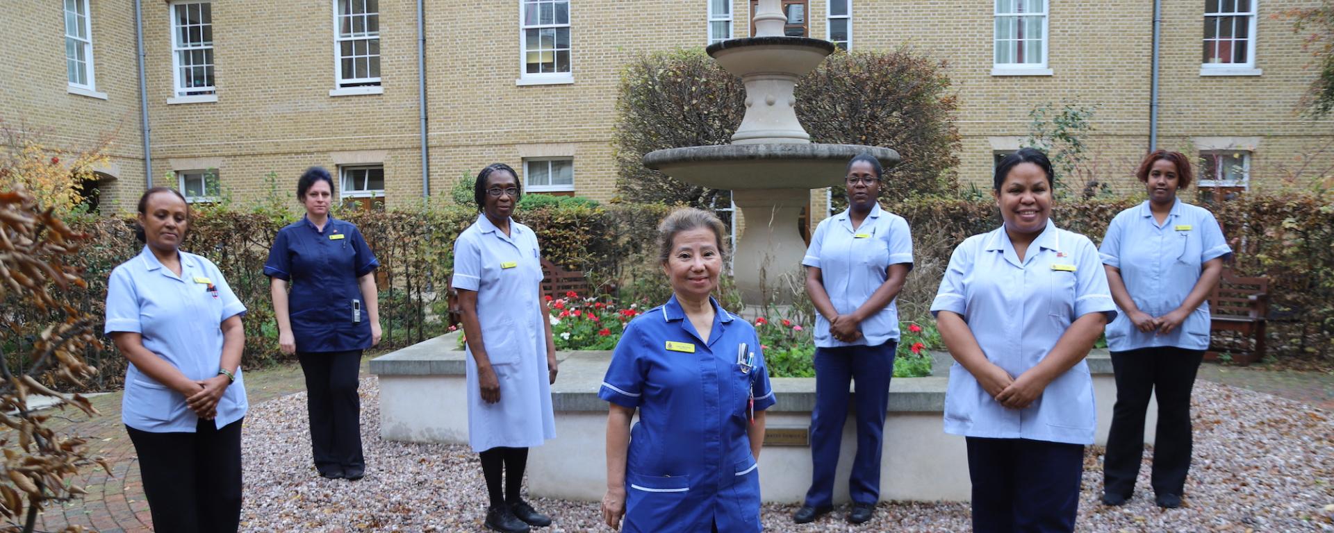 Nurses and care staff gather in the courtyard of the Margaret Thatcher Infirmary at The Royal Hospital Chelsea