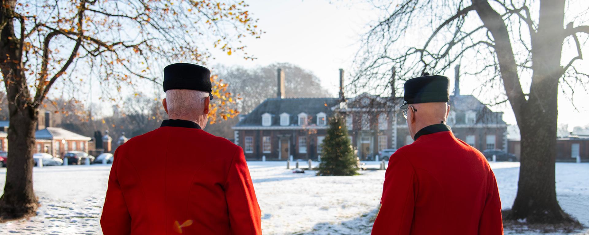 Chelsea Pensioners look out over a snow covered Light Horse Court