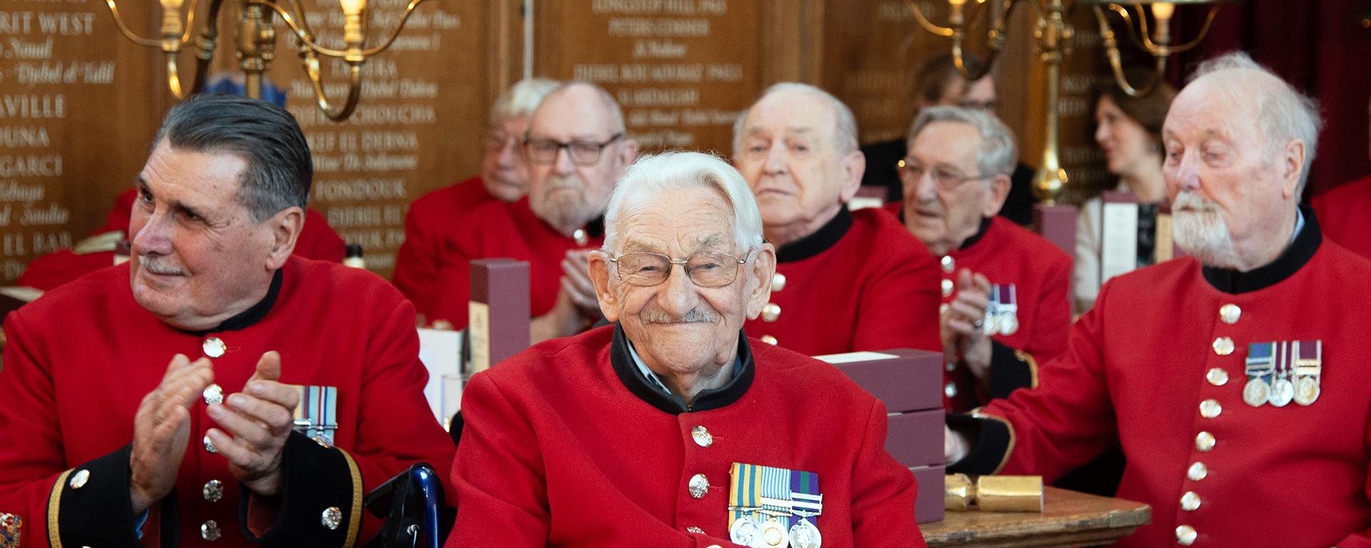 Chelsea Pensioners gather in the Great Hall for Christmas festivities
