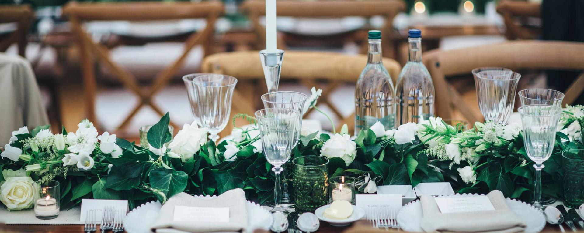 table set for fancy meal with flowers and candles