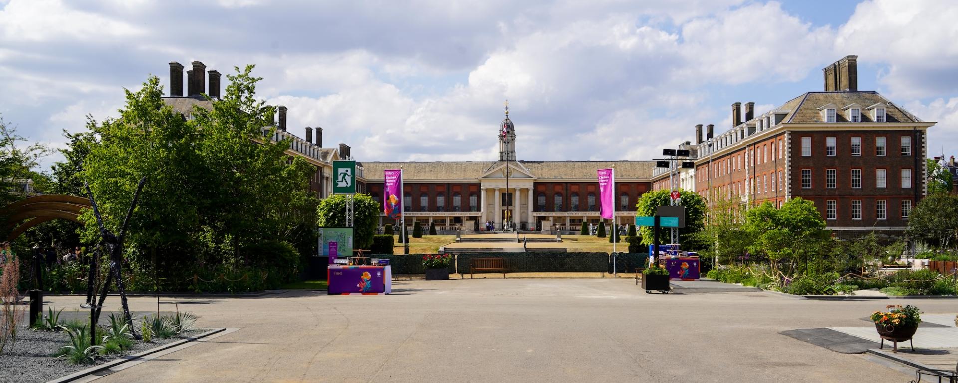 The Royal Hospital Chelsea is the backdrop to a photo of Chelsea Flower Show 2025, with shrubs, trees and banners in the foreground