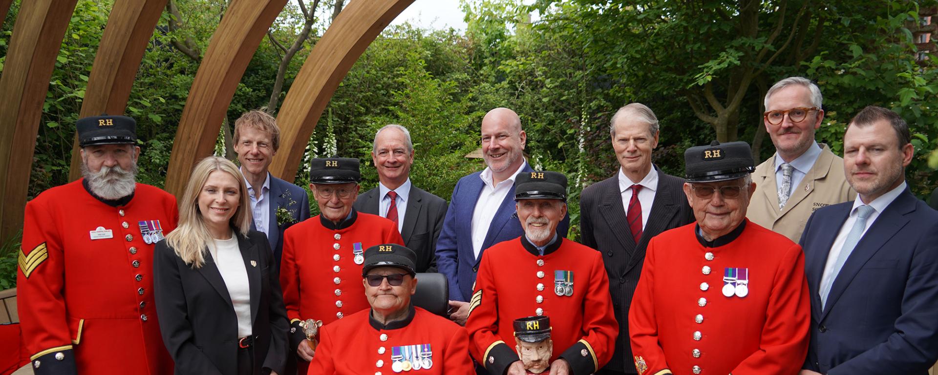 Chelsea Pensioners stand alongside the CEO and Governor of The Royal Hospital Chelsea, with designers of the Chelsea Pensioner Garden 2025