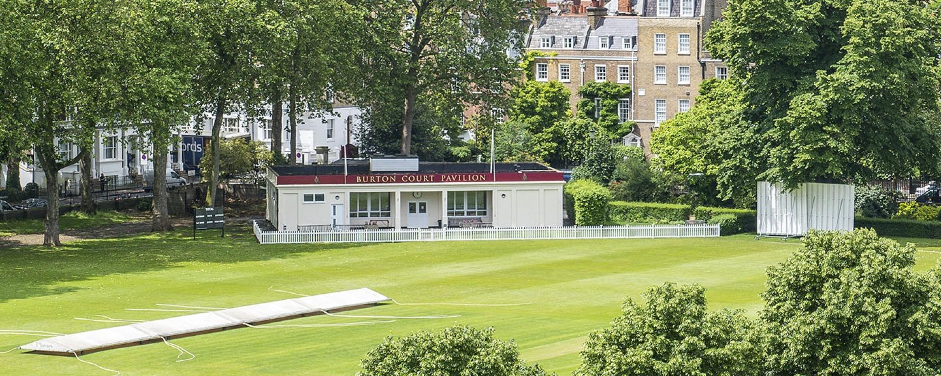 Burton Court cricket ground at the Royal Hospital Chelsea, featuring the pavilion, cricket square and mature trees in a secluded central London setting.