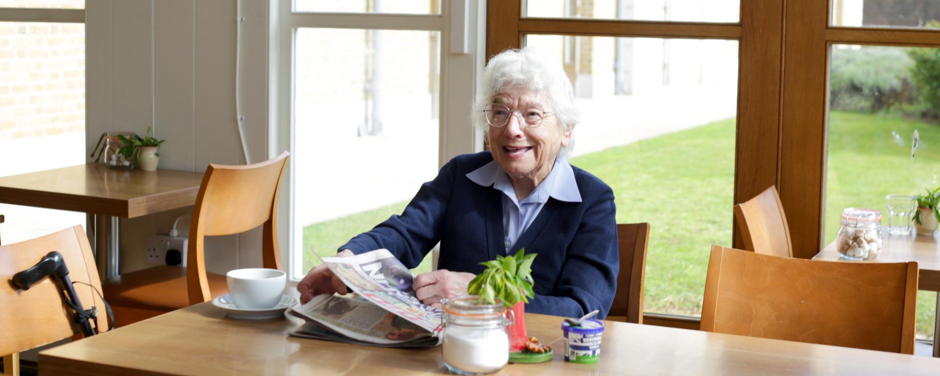 Chelsea Pensioner Marjorie sitting in a cafe at Royal Hospital Chelsea