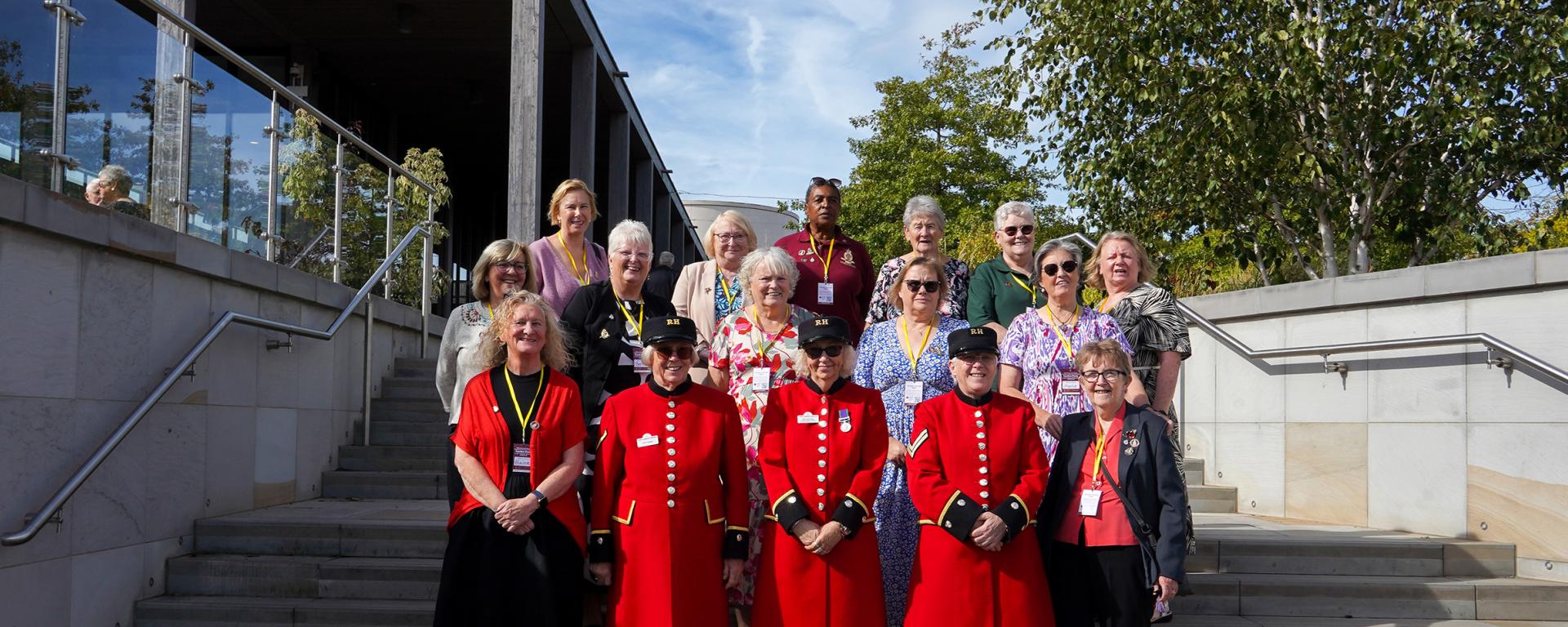 Chelsea Pensioners in scarlet uniforms with veterans and guests at the Chelsea Pensioners Veterans Outreach Garden Party at the National Memorial Arboretum.