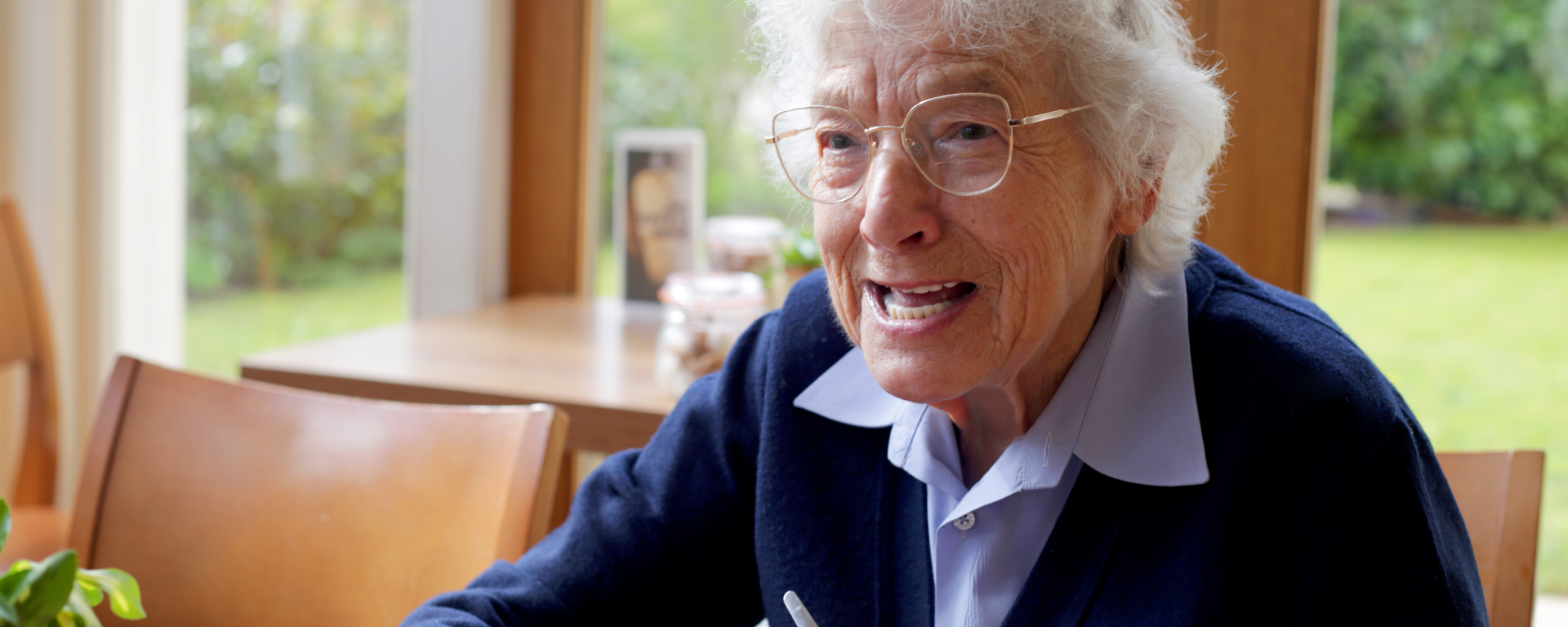 Chelsea Pensioner Marjorie sitting in a cafe at Royal Hospital Chelsea