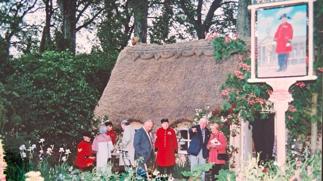 Pensioners and guests gather at the Chelsea Flower Show at the best in show garden A Soldiers Dream of Blighty