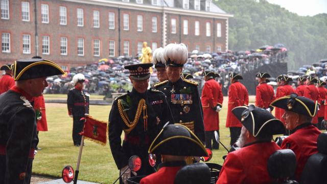His Royal Highness The Duke of Edinburgh stands alongside the Governor of The Royal Hospital Chelsea, Sir Adrian Bradshaw on figure court in pouring rain as they review the Chelsea Pensioners at Founder's Day 2025